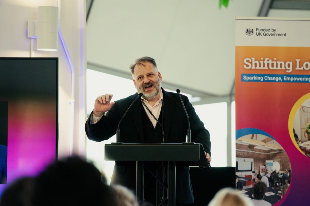 Howard Dawber Deputy Mayor of London for Business and Growth, stands at a lectern delivering his keynote speech